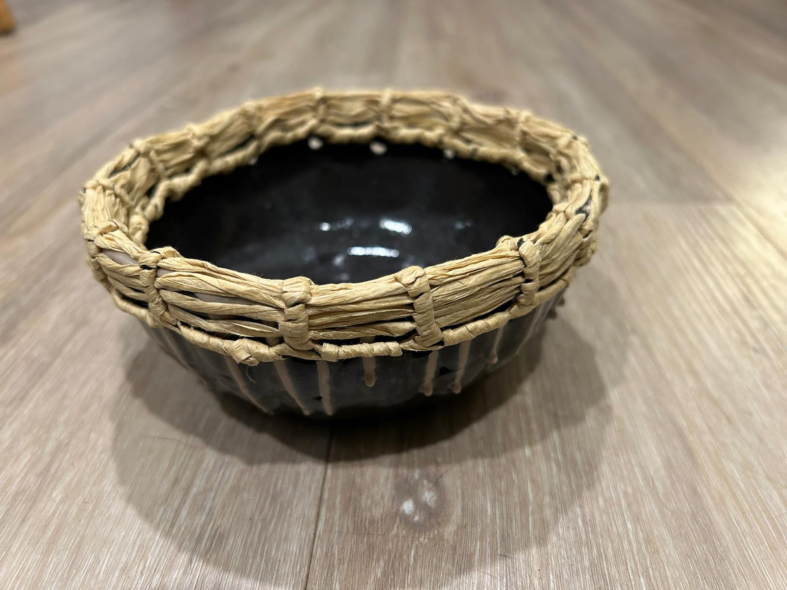 Black ceramic bowl with woven harakeke rim