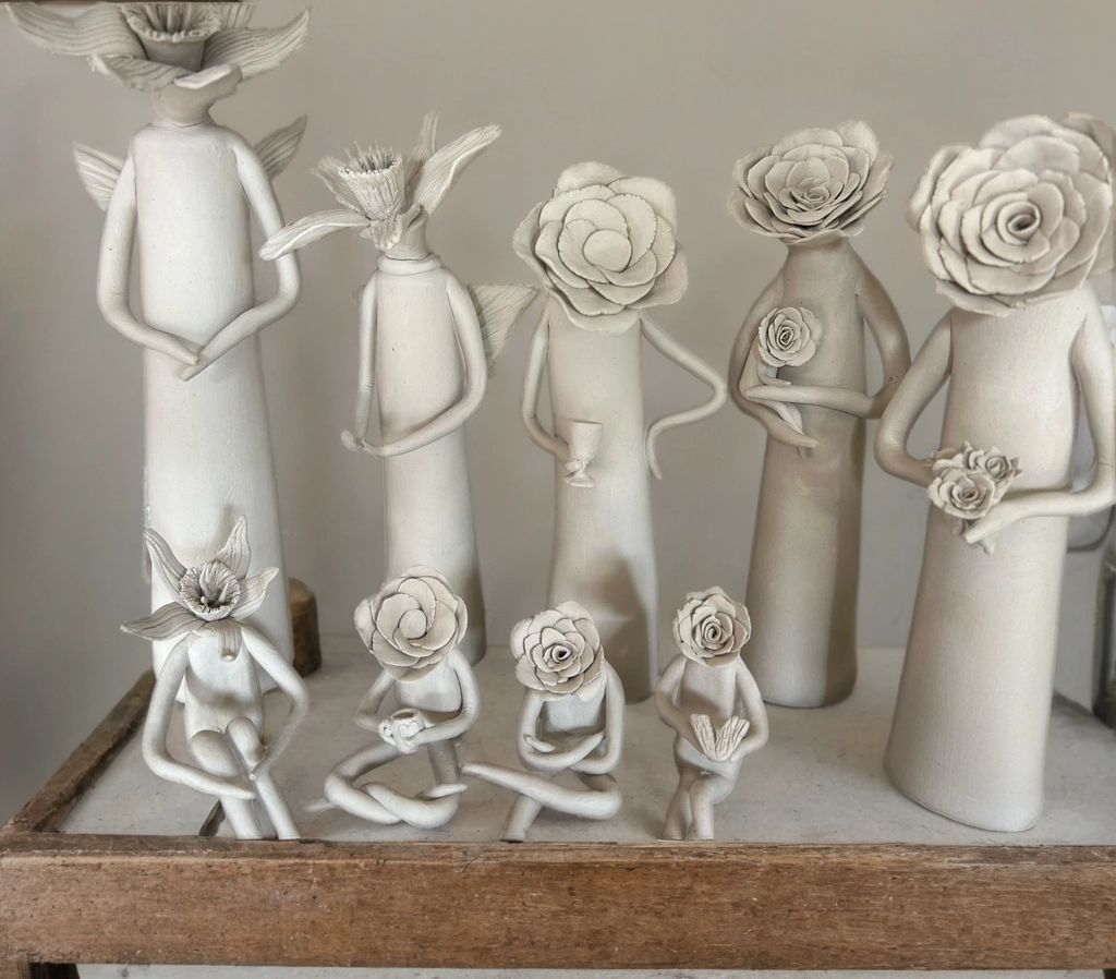 Ceramic sculpted figures with flower heads