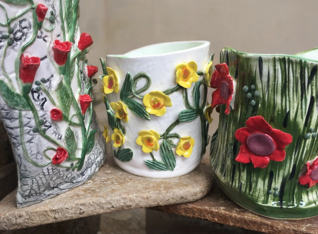 Three decorative vases with applied clay flowers